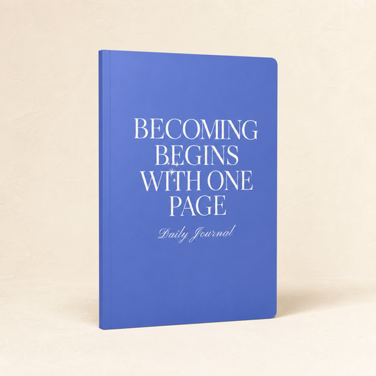 Blue Becoming Begins with One Page daily journal on a warm ivory background