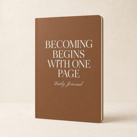 Brown Becoming Begins with One Page daily journal on a warm ivory background