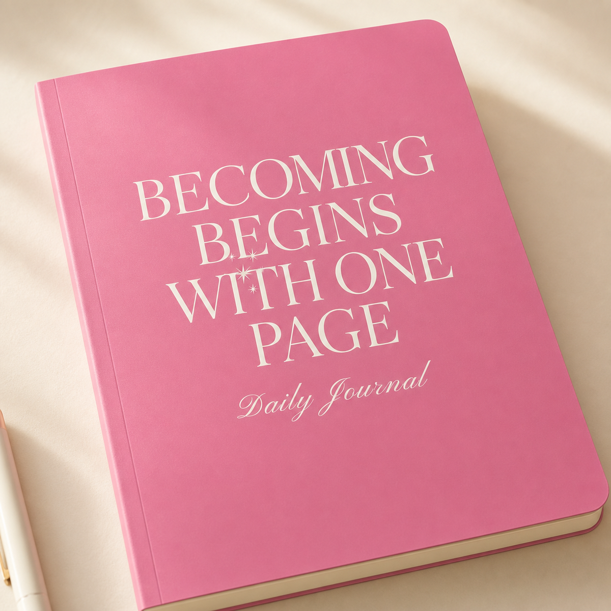 Close-up of the pink journal satin cover, rounded corner, and cream typography